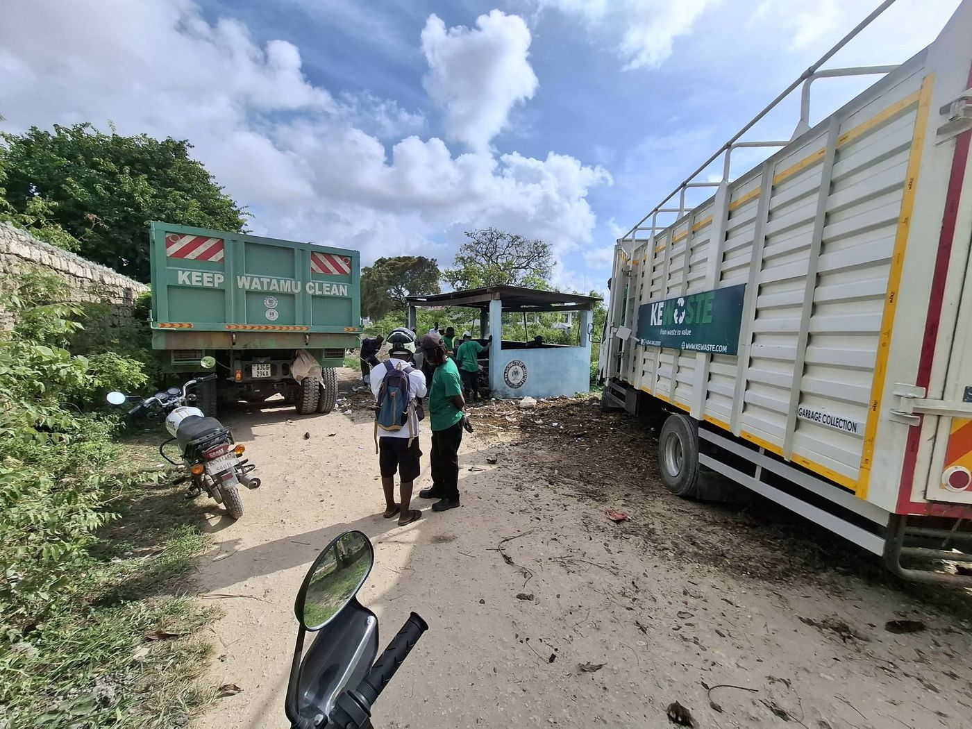 A Watamu Municipality truck and a KEWASTE truck at a municipal collection point